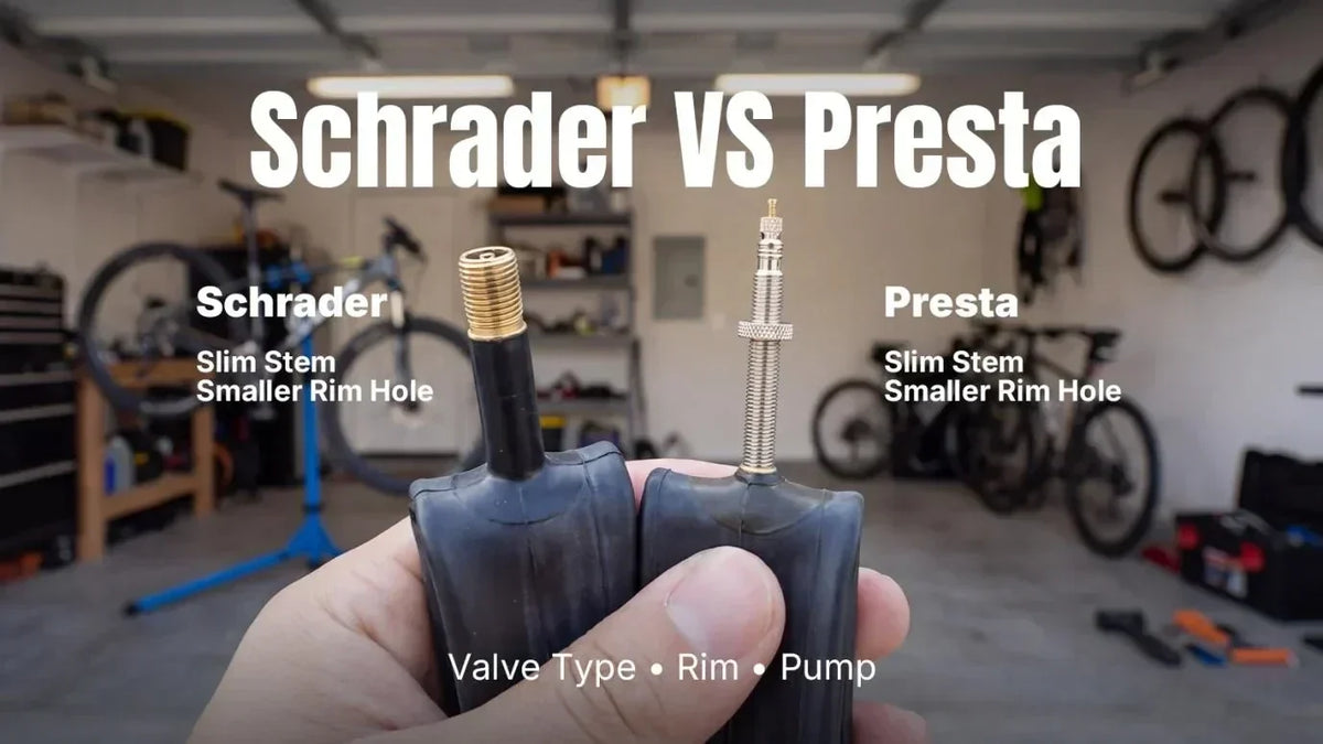 Hand holding two black inner tubes with metal valves, labeled Schrader vs Presta.